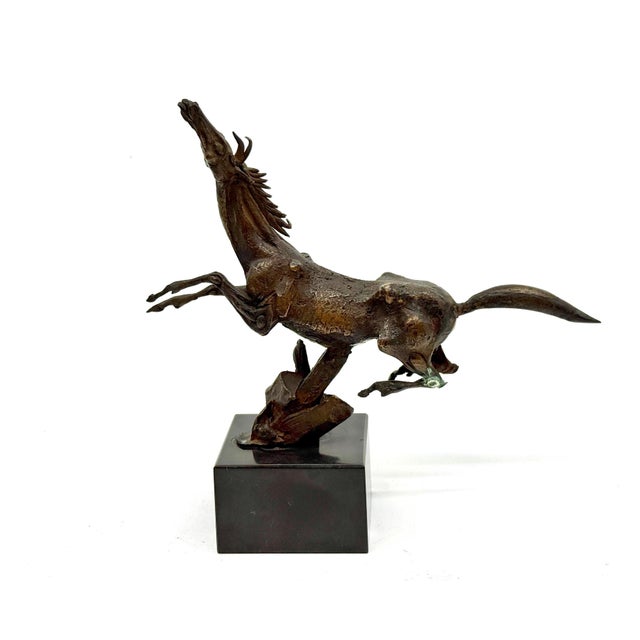 A beautifully detailed bronze of a jumping horse on a marble base by the talented, noted American Sculptor Frank Eliscu....