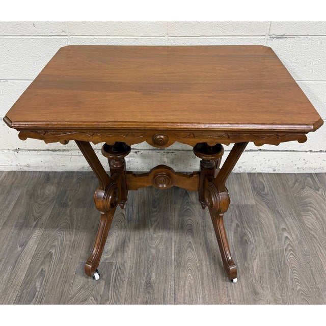 This is a gorgeous antique Victorian Eastlake library table crafted in solid oak, featuring a distinctive trestle base...
