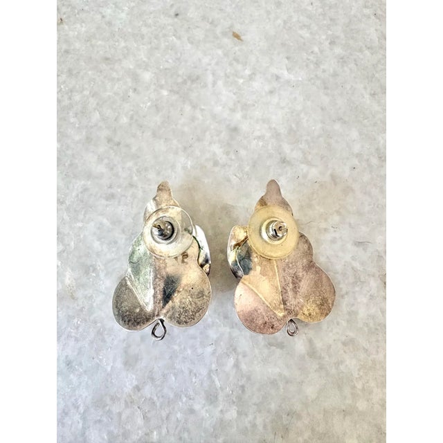 Gorgeous, vintage sterling silver leaf shaped earrings with amethyst stone accent.