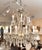 Vintage English Regency style 16-light crystal two-tier chandelier, profusely hung throughout with scalloped pendants.