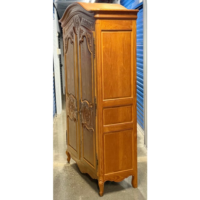 Gorgeous Henredon French armoire from the Four Centuries collection. Two full length carved paneled doors open to an...