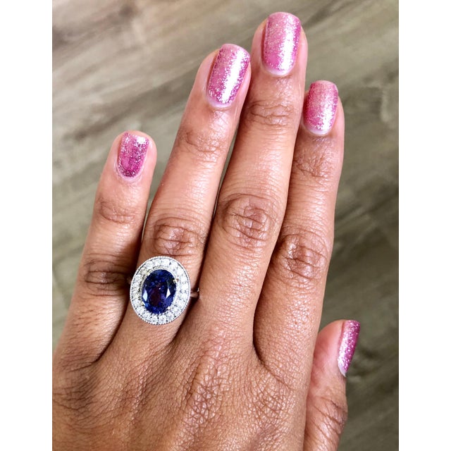 This gorgeous Tanzanite Diamond Ring has a 3.63 Carat Oval Cut Tanzanite as its center stone and has 20 Round Cut Diamonds...