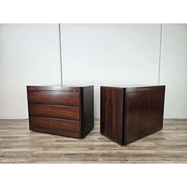 A pair of Italian-made storage units from the 1970s, crafted from rosewood veneer and featuring a rigorous, geometric...