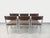 Six vintage chairs from the 1970s, with a chromed metal design, dark brown faux leather seats and backs, and a tubular...