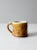 This is a vintage studio pottery mug from Daybreak Pottery. The hand-crafted ceramic mug features stamped circles designs...