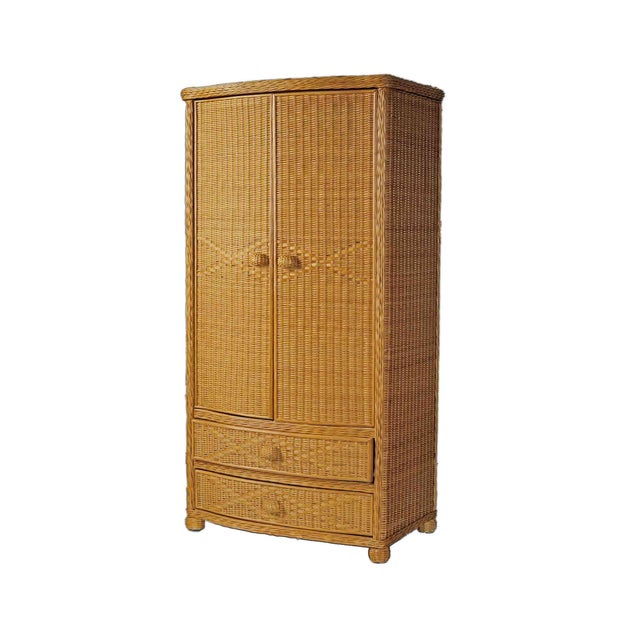 Vintage Pier 1 tan wicker armoire. Dowel for hanging clothes, upper shelf and two sliding drawers below.