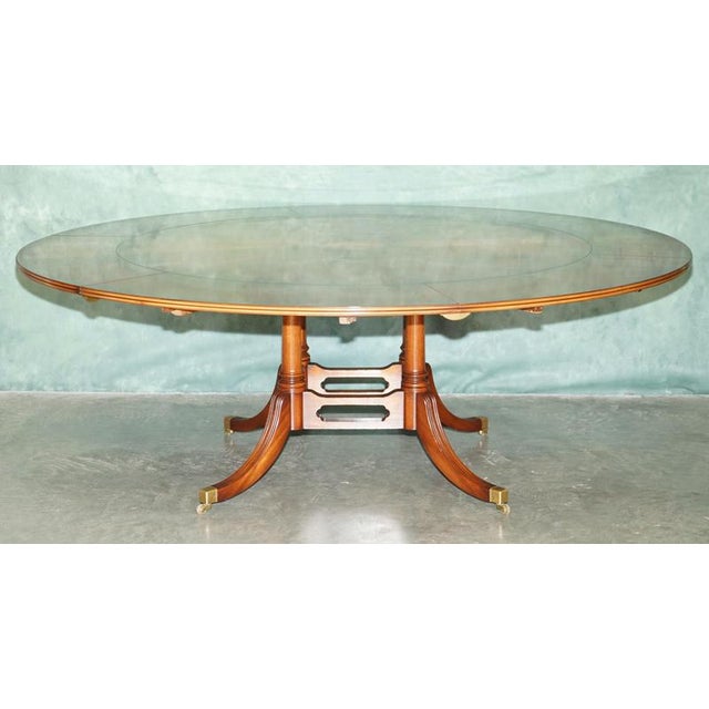 Exceptional Bevan Funnell Jupe extending circular dining table, beautifully made in England in richly figured burr walnut...