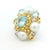 A vibrant and dimensional cocktail ring showcasing a richly layered cluster of aquamarines, cultured pearls, yellow...