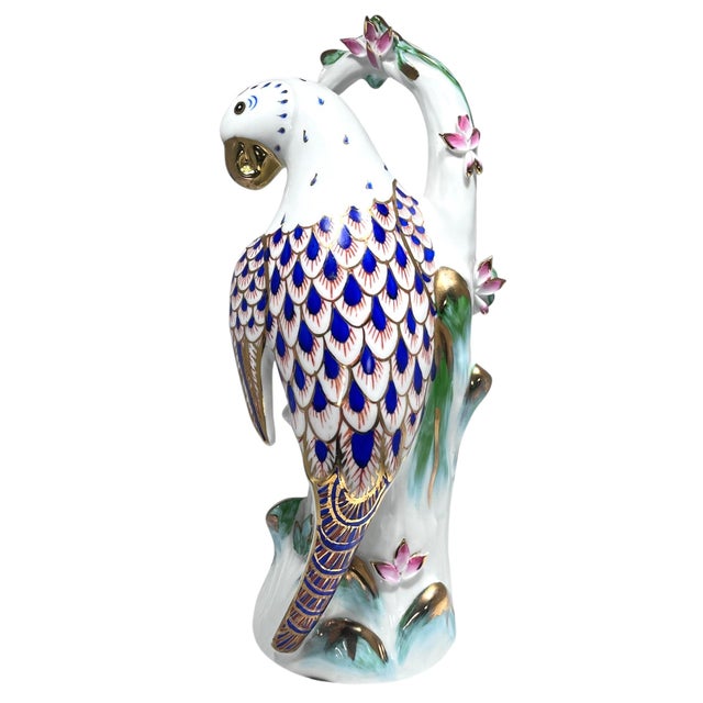 Add some charm to your decor with this meticulously hand-painted porcelain parrot with gold gilt highlights by KPM. KPM...