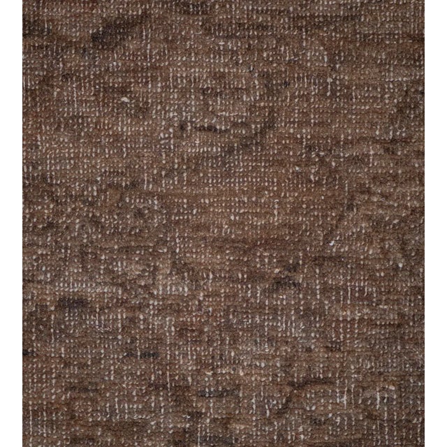 This revival Agra style rug features a burgundy-brown field with an overall design of palmettes and floral vine around...