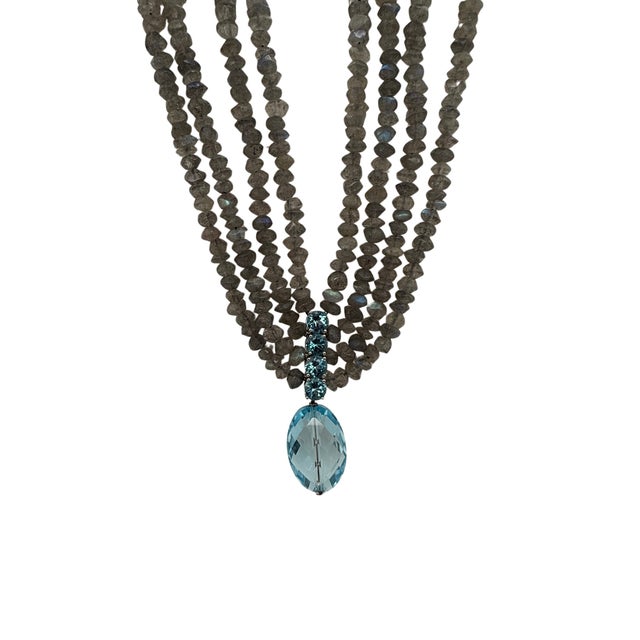 A fine vintage four strand labradorite bead necklace with a prong set blue topaz spacer leading to a faceted tear shaped...