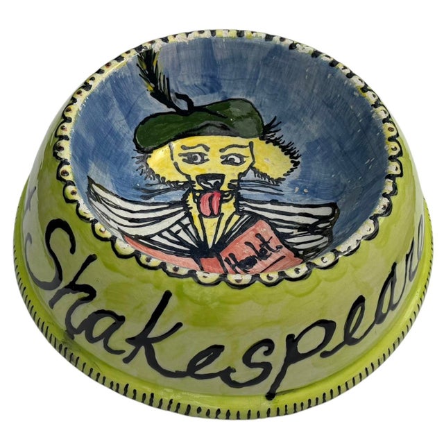 A wonderfully expressive hand-painted folk art decorative bowl featuring a dog reading Hamlet, with the exterior inscribed...