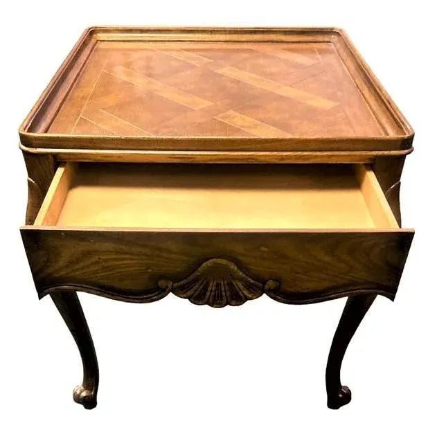 Handsome Baker Furniture Company side table in oak with a dark finish and parquetry top. Single drawer. A matching table...