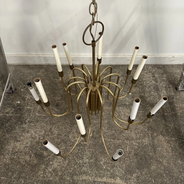 Mid Century Modern brass chandelier attributed to Tommi Parzinger for Lightolier. 12 delicate brass arm chandelier with...