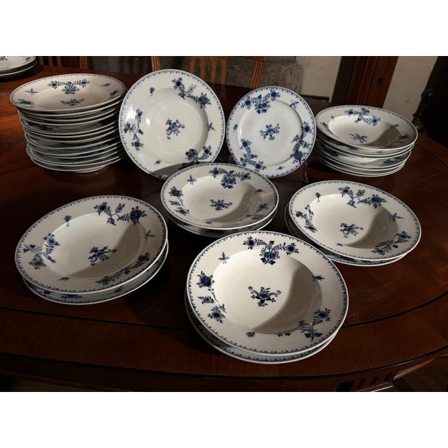 An elegant forty-four (44) piece blue and white porcelain plates set with Floral and Insect decoration, a magnificent...