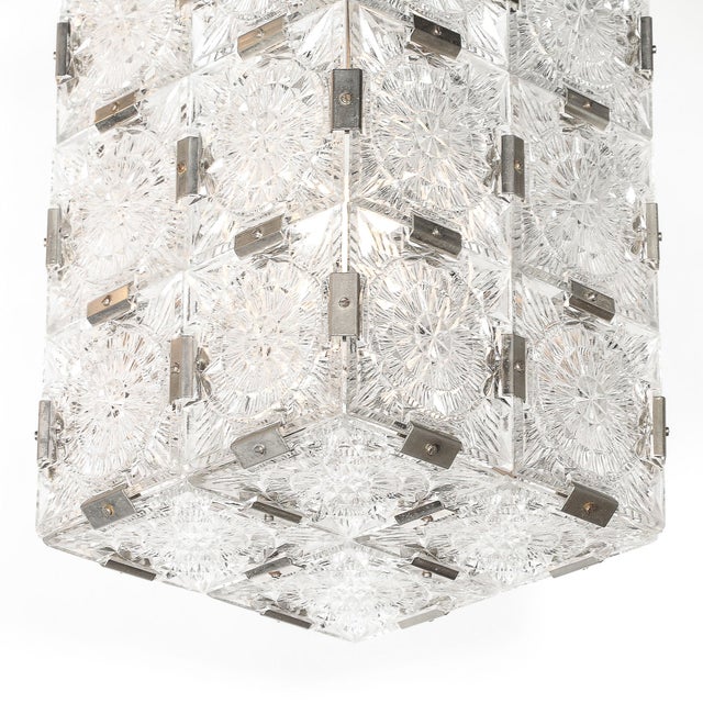 This pair of Mid-Century Modernist pendant chandeliers, crafted by the esteemed Austrian lighting manufacturer Kinkeldey,...