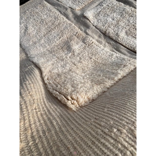 This authentic Moroccan Mrirt rug is entirely hand-knotted from 100% natural wool by skilled artisans in the Middle Atlas...