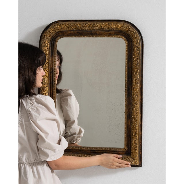 A classic Louis Philippe mirror characterized by its rounded corners and simple, elegant frame. The restrained design...