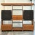 Stunning Mid-Century Modern chrome, smoked glass, and faux wood wall unit in the manor of John Stuart. This is an...