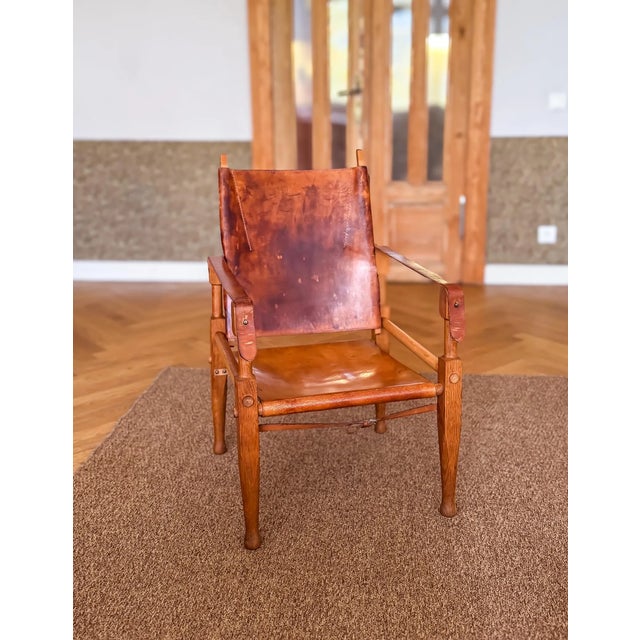 One wonderful natural dark oak wood safari chair, designed by Wilhelm Kienzle / Kare Klint, in 1928 for Wohnbedarf and...