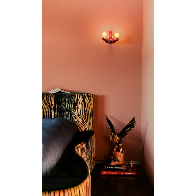 Upholstered in premium patterned velvet, Sculptural rounded silhouette, Integrated contenitore storage compartment Labeled...