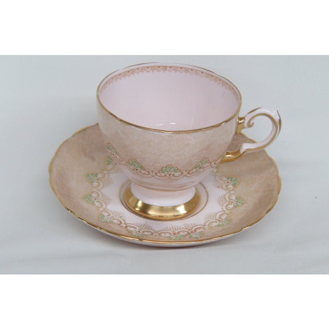 This lovely tea cup and saucer set is made of porcelain and this tea set is stamped by Tuscan England. Both pieces have a...