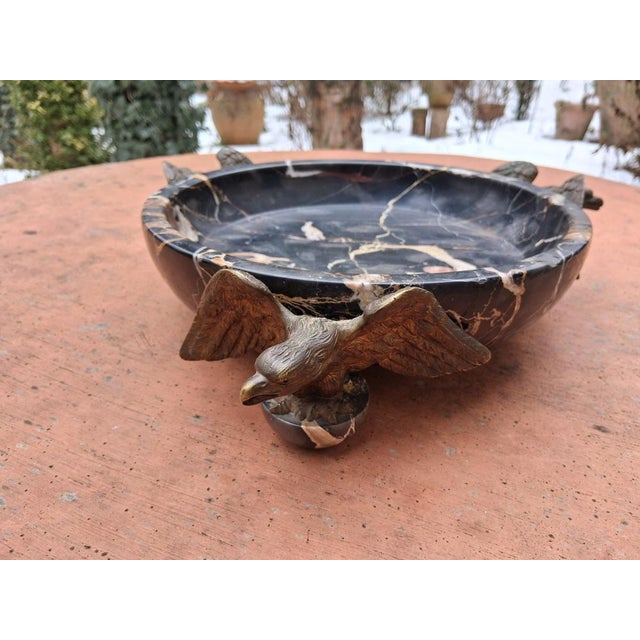 An exceptional antique marble bowl supported by three bronze eagles—a true eye-catcher. There are chips on the marble rim...