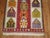 A vintage turkish Kilim flat-weave with a directional motif of small homes.