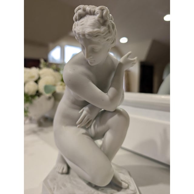 Bring classical elegance to your tabletop with this exquisite antique porcelain bisque sculpture of the Crouching Venus...