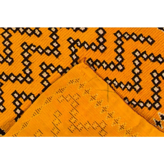 A modern Moroccan rug from the 21st century featuring a burnt orange field and an abstract geometric design in brown and...
