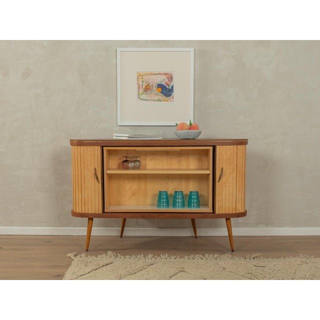 A wonderful corner cabinet from the 1950s with an integrated bar compartment. High-quality body in walnut/ash veneer with...
