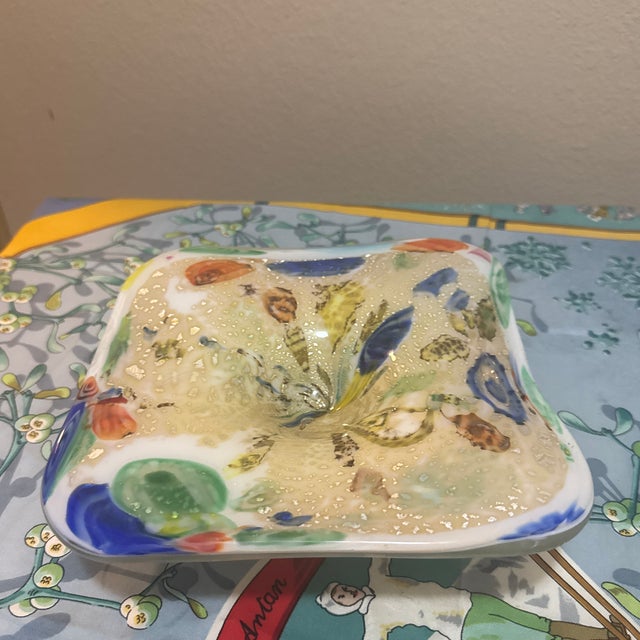 A captivating vintage square art glass catchall dish blending organic forms with mid-century style. The dish features a...