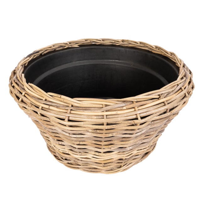 Bring a touch of nature into your home with our Round Cone Rattan Planter. Handwoven from natural rattan, this cone-shaped...