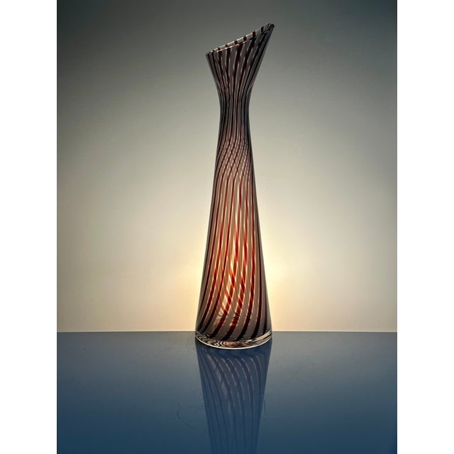 This tall and elegant overlay glass vase is distinguished by its sophisticated, traditional "à canne" technique. The...