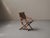 Elegant folding armchair, dating from the early 1900s, is a beautiful example of European campaign-style furniture,...
