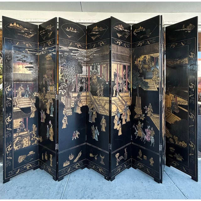 Monumental Chinese Lacquered 8-Panel Coromandel Screen Depicting Court Scenes Offered for sale is a monumental Chinese...