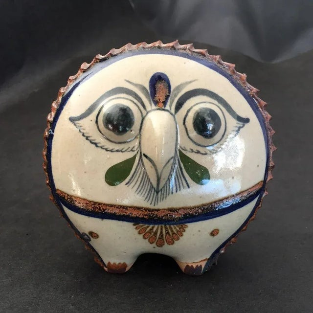 Vintage, owl pottery figurine with floral design in the back signed "R". Dimensions 5"W X5"H X 3"D