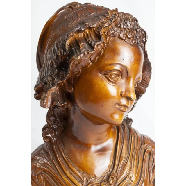 Sculpture made of fine Swiss pine wood by the artist Porro di Cantù in 1981 It depicts the bust of a peasant woman and is...