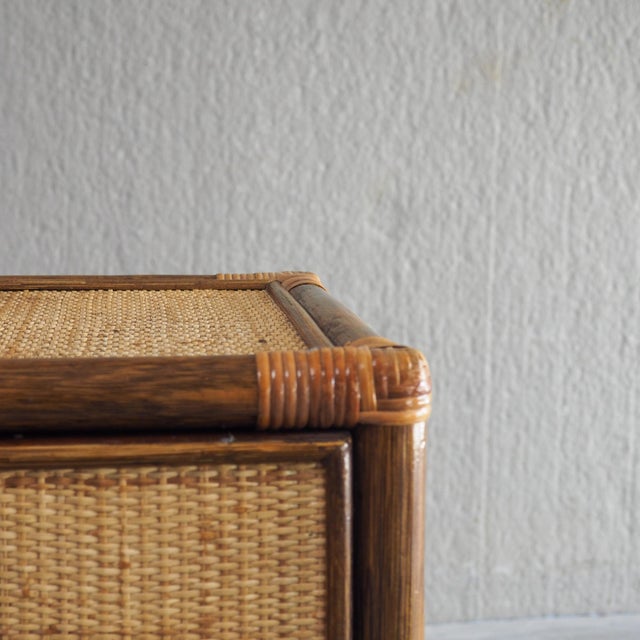 Versatile vintage accent cabinet, crafted with a rich dark rattan framework and finely woven light cane paneling....