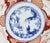 Imari charger featuring the three friends of winter: pine, prunus, & bamboo in the central medallion, surrouned by panels...