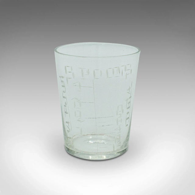 This is an antique apothecary medicine cup. An English, glass and leather chemist's measure, dating to the Victorian...