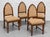 A striking set of four Dutch Art Deco oak dining chairs attributed to the Amsterdam School, circa 1930s. Tall, pointed...