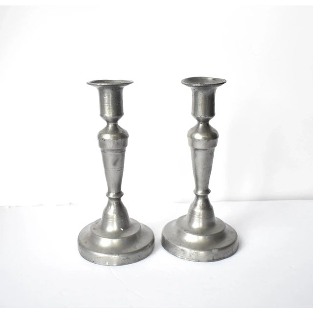 A pair of antique, late 18th-century, c. 1795 round, heavy pewter candle sticks for taper candles, with etched birder...