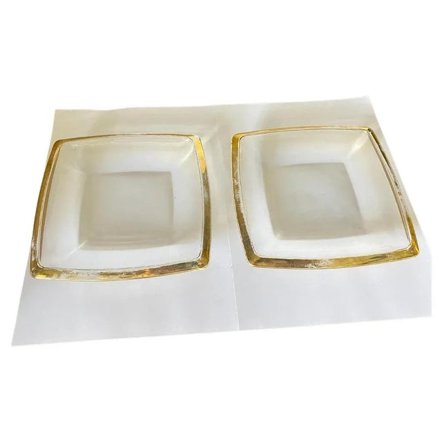These vide poche or ashtraye in in Glass. It has been done circa 1970, in France. They are squre shaped with Golden...