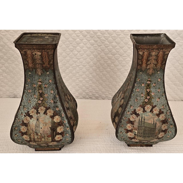 This matching pair of antique toleware vases features softly waisted forms with flared rims, hand-decorated with romantic...