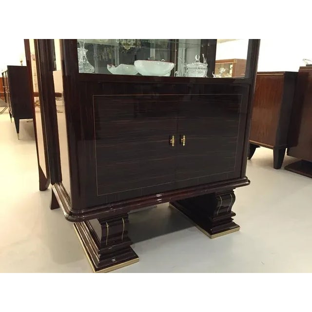 This French Art Deco vitrine with faux ivory trim has been professionally refinished by a third generation restorer....