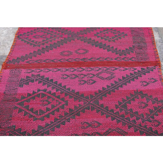 Handwoven in wool circa 1950–1960, this 5x6 vintage Kilim, woven in the tradition of a Frazada textile, is a striking...