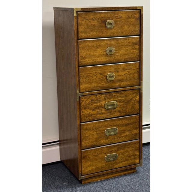 Beautifully crafted six-drawer chest featuring a warm, richly grained wood finish and classic campaign-style detailing....