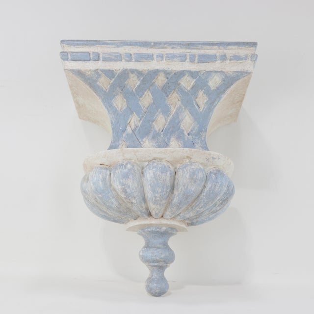 A stunning pair of French Provincial-style carved wall brackets, featuring an aged blue and white finish with intricate...