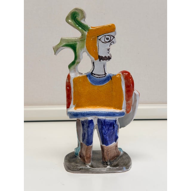 De Simone Italian pottery piece featuring a knight, shield, and sword reflects the vibrant, Picasso-inspired folk art...